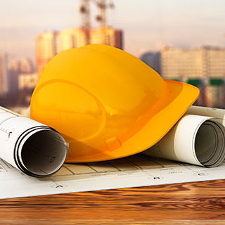 Inszone Insurance Construction Page Banner - Construction Safety Hat and Blueprints on Table