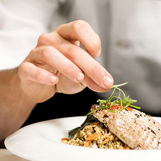 Chef Arranging Food on Plate - Lead Image for Fine Dining Page