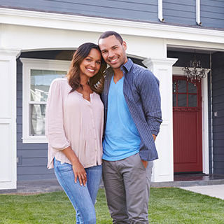 Inszone Home Insurance Page Banner - Couple Standing In Front of Their House