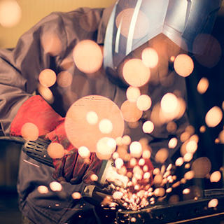 Worker Using Angle Grinder - Lead Image for Manufacturing Page