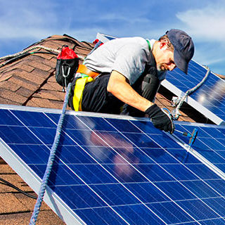 Solar Panel Installer Fixing a Panel - Lead Image for Solar Page