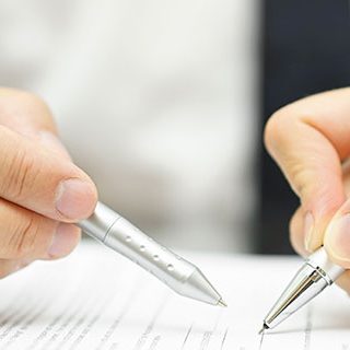Inszone Insurance Surety Bonds Page Banner - Two Corporate People Signing on Paper