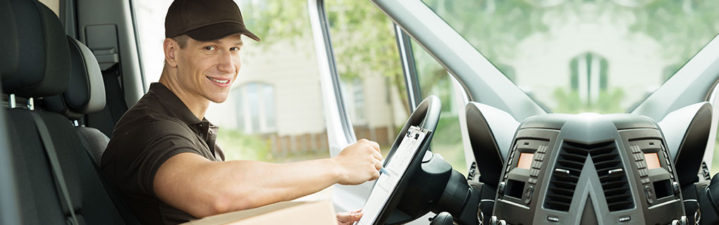 Male Delivery Driver Sitting in the Car - Lead Image for Delivery and Courier Page