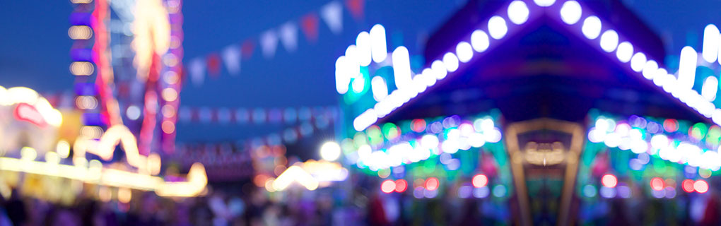 Blurry Amusement Park Image at Night - Lead Image for Fairs and Carnivals Page