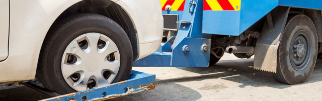 Tow Truck Towing a Vehicle - Lead Image for Tow Services Page