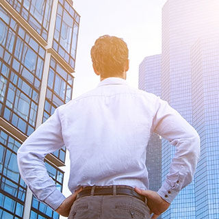 Business Man Facing Tall Building - Lead Image for Lessors Risk Page
