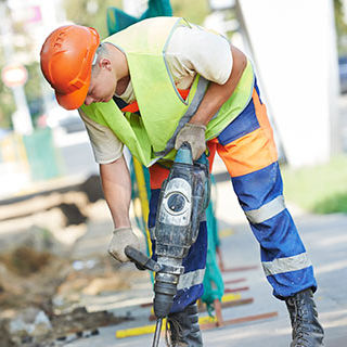 Male Worker Using a Jack Hammer Drill - Lead Image for Street and Road Construction Page